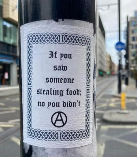 Poster on a pole that says If you saw someone stealing food; no you didn't"