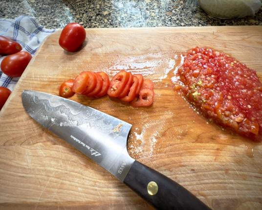 San Marzano tomatoes becoming pizza sauce with big knife on my cutting board.