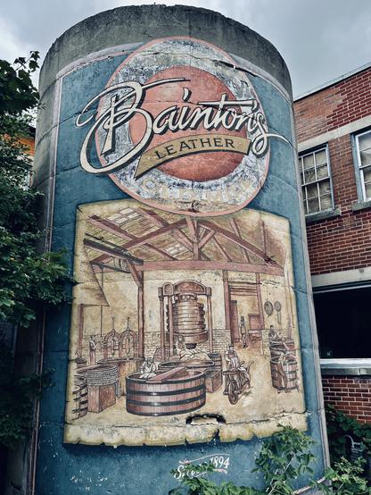 Hand painted sign for Bainton’s Leather tannery that was on this site, including a cutaway view into the works, where hides can be seen being hoisted, shipped on pack animals, etc.