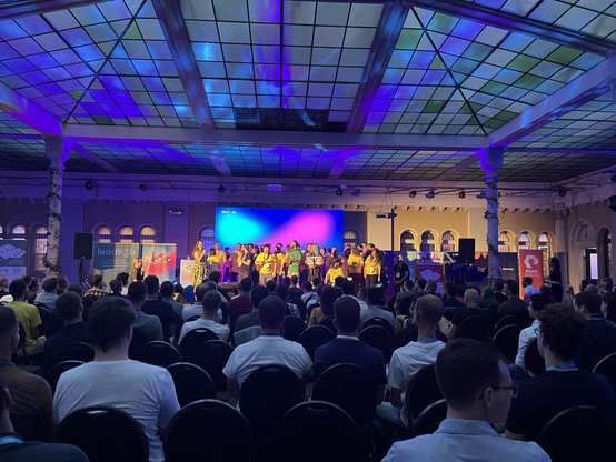 Volunteers and organizers on the stage during the closing ceremony of the conference