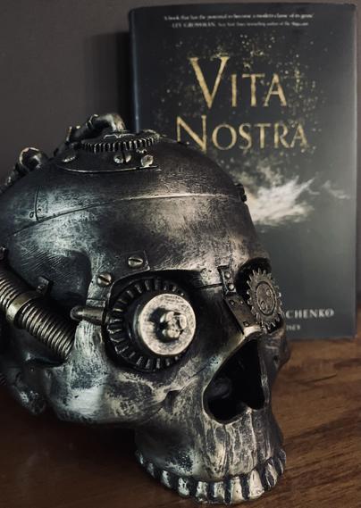 Vita Nostra is pictured on a wood shelf behind a steampunk skull. Photo by AHS.