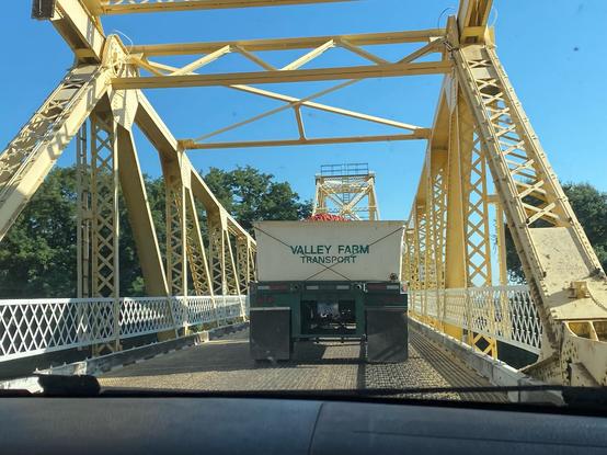 photo of the freshest tomatoes being taken across a bridge. company called Valley Farm Transport.