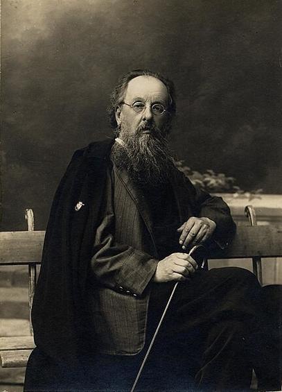 Portretfoto pri Ciolkovskij je ĉirkaŭ 1924. Li sidas sur benko kun bastono en la dekstra mano. Li portas grizan larĝstrian jakon, malhelan pantalonon, kaj nigra mantelo drapiriĝis super liaj ŝultroj. Li havas okulvitron kaj longan barbon.