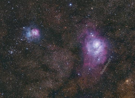 The two nebulas described in the test. The Trifid nebula is small, and has two coloured lobes, one blue, and one magenta. The lagoon nebula is much larger, and different shades of white and magenta. The yellowish colour of the milky way’s galactic dust can be seen in the background, among hundreds of thousands of stars.