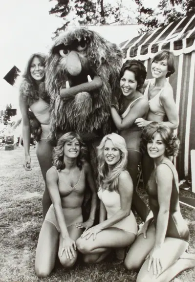 Muppet Sweetums is surrounded by a bevy of bikini clad beauties