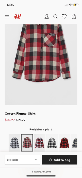 H&M kids flannel shirt originally priced at $19.99 with the 19.99 crossed out and replaced with $20.99.