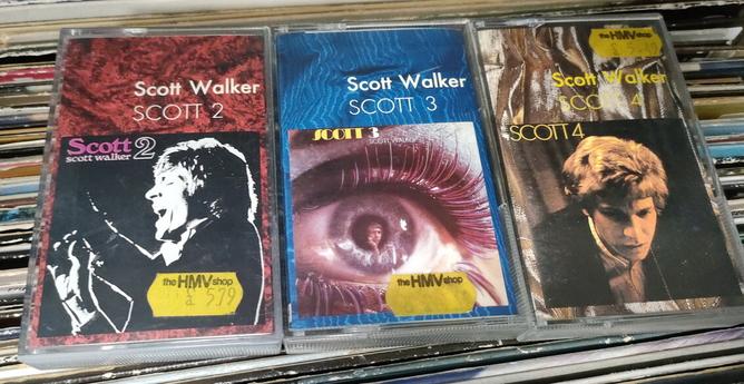 Three cassette tape boxes, Scott Walker albums Scott 2, Scott 3 and Scott 4. Each has an old HMV shop price sticker, asking a little over £5. Not pictured is the rear of the boxes, where they're priced at £2 each because they're just in a bargain bin in the corner of this place. Score!
