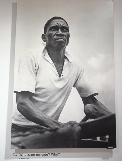 BW photo: Portrait of a black man. Underneath: 'Who is on my side? Who?'