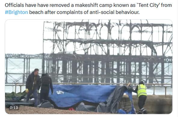Photo shows people removing tents from Brighton beach, text reads "Officials have have removed a makeshift camp known as `Tent City' from #Brighton beach after complaints of anti-social behaviour."