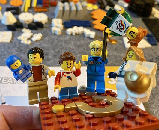 Six minifigures. A blue spacebaby. Two children and three adults.