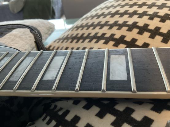 fret board with frets showing signs of leveling