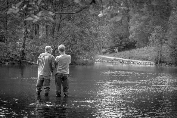 Bnw photo. Two men are fishing in a small lake.