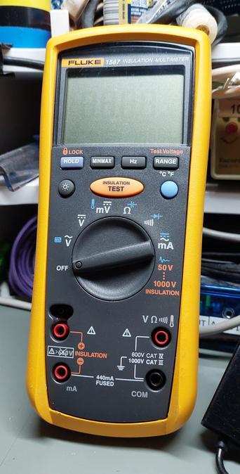A Fluke 1587 Insulation Multimeter with its yellow sleeve still on.