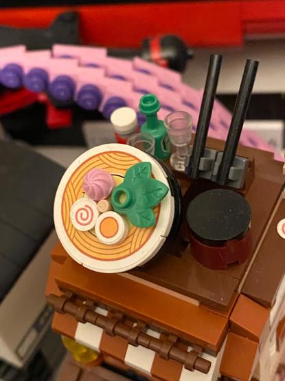 Close up of ramen on top of Brick toy Chinese noodle restaurant