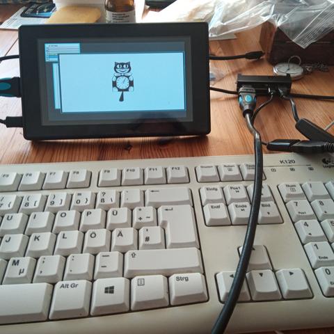 Same raspberry pi zero w with keyboard, screen and mouse attached.
Screen shows rio(1) with catclock(6).