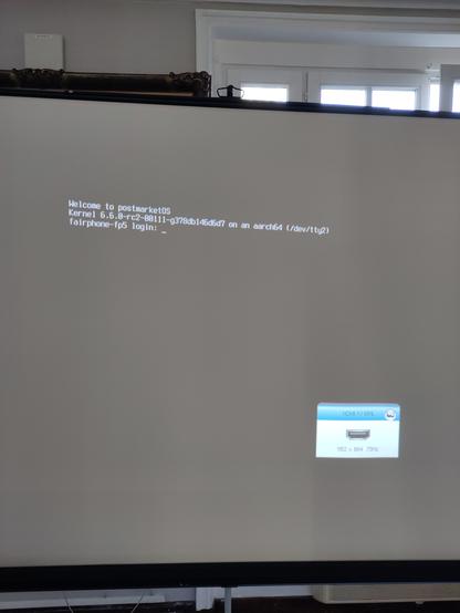 A Linux tty prompt on a projector showing fairphone-fp5 and kernel 6.6.0-rc2.