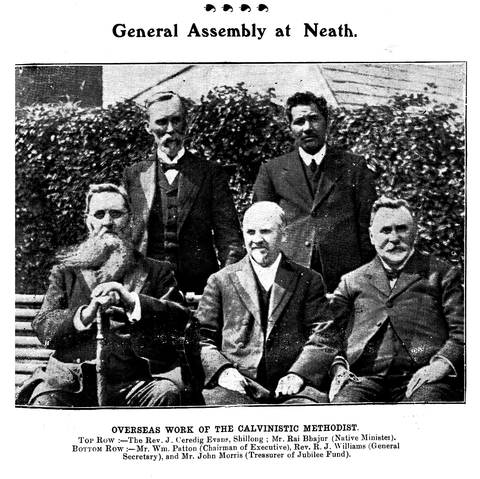 Group image of five bewhiskered Calvinist reverends and dignitaries. The gentleman standing on the right in the second row is the Rev. Rai Bhajur, who appears more youthful when compared to his white colleagues. His hair is short, a little tousled and he wears a mustache. His clothes are of the typical sober style of a Methodist man of the cloth.