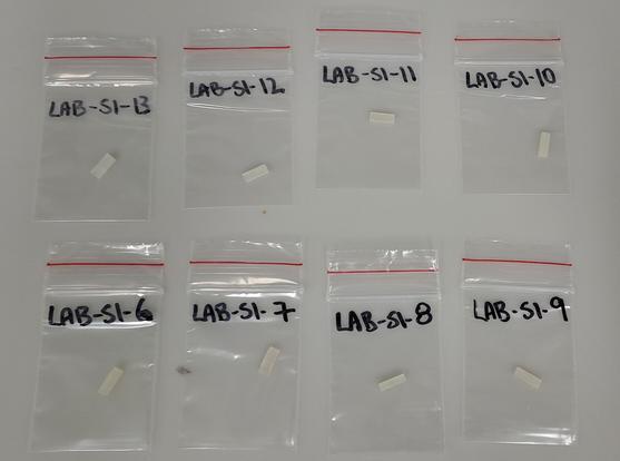 8 small slivers of rock in neatly labelled bags.