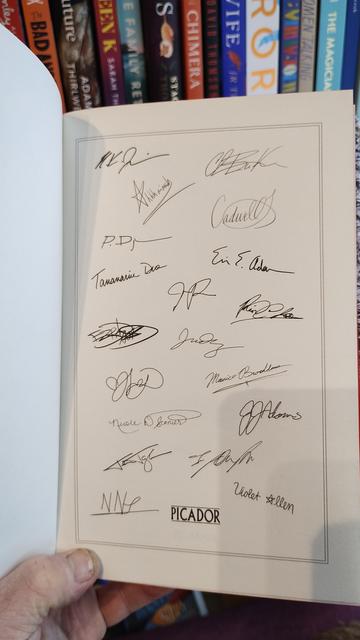 multiple signatures inside the anthology, from many of the writers featured.