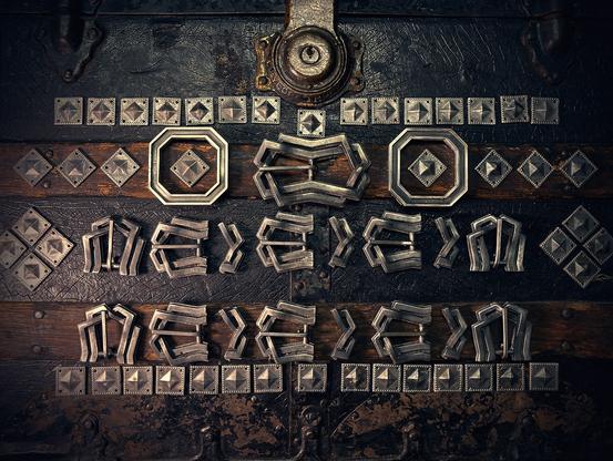 Photo of a large array of metal buckles and accessories based on the costume worn by Kili in The Hobbit series. They are resting on an antique steamer trunk.