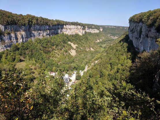 View of a long deep forested limestone valley (reculee) in Baume Les Messieurs in France. taken from the belvedere at Crancot.