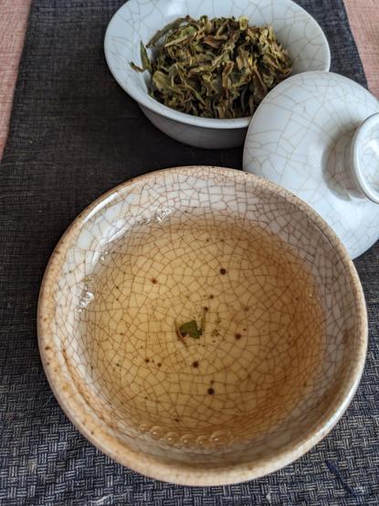 Green tea in a bowl and gaiwan.