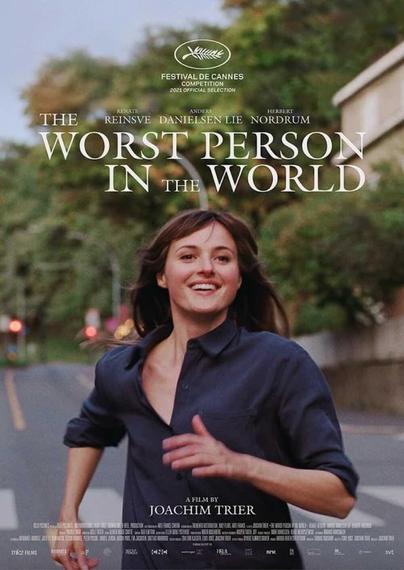 Renate Reinsve runs down a city street, smiling
