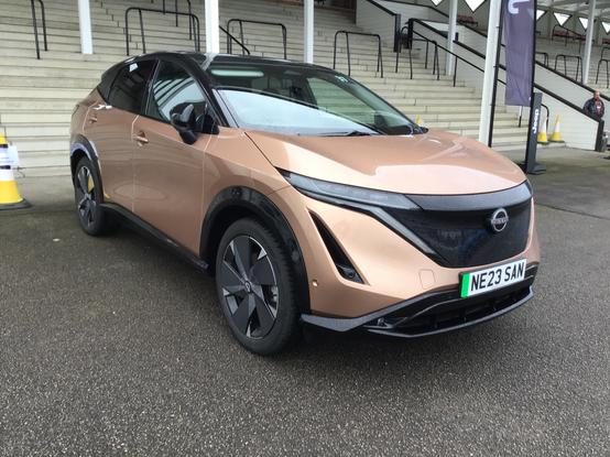 Copper metallic Nissan Ariya with black roof, front quarter view