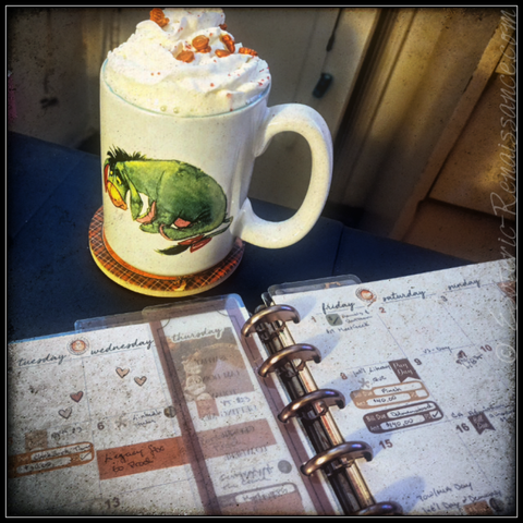 A planner lays open to the mouth of September, The planner pages are decorated with stickers using an autumn theme

Next to the planner, at the top of the image, is a mug of hot cocoa with whipped cream and pumpkin-shaped sprinkles.