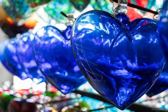 Blue, glass hearts in a row.