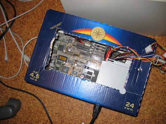 Ultra 10 motherboard and ATX PSU inside a Lapin Kulta 24 pack cardboard beer case.