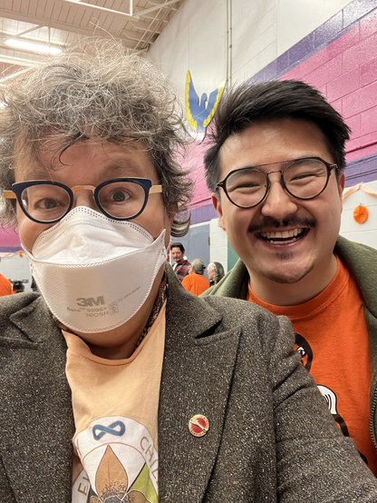A selfie of me, in an orange shirt, brown tweed blazer and white N95 mask, taken with Métis MP Blake Desjarlais, .the member for Edmonton Griesbach in his orange shirt