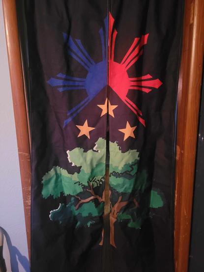When I ordered this tapestry, I chose one that could be customized. I added a design consisting of a Narra tree featuring the Filipino sun and stars above it. For the background color, I chose black. Half of the Filipino sun is blue and the other half is red. As is typical, there are 3 yellow 5-pointed stars underneath the sun.