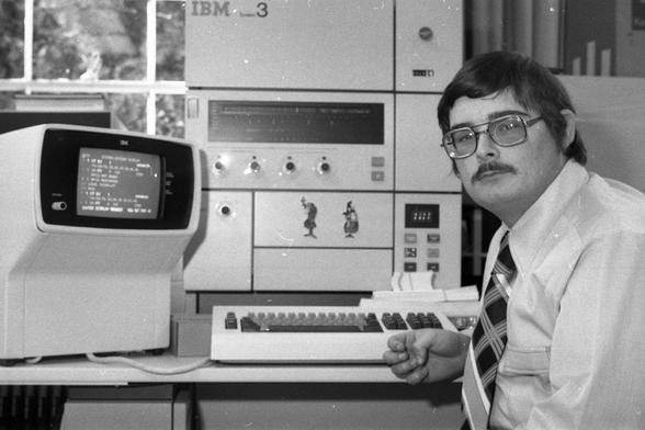 Unidentified man at an IBM System/3 computer, ca. 1973-1978