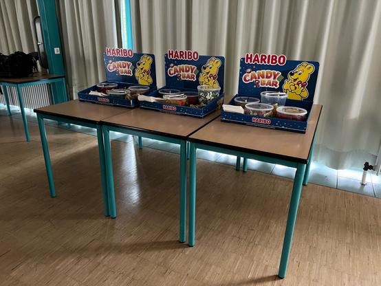 Haribo-Candybar auf Schul-Tischen, der Raum ist leicht abgedunkelt…