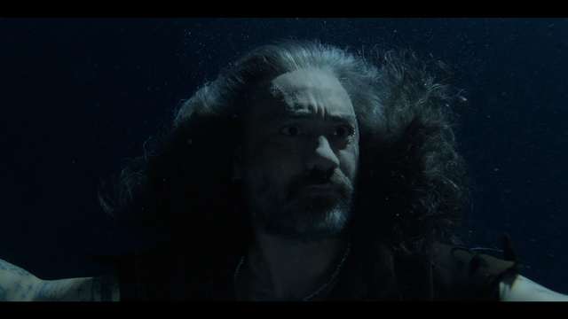 Screenshot from the show Our Flag Means Death. Ed, the male lead, is sinking underwater in the ocean.