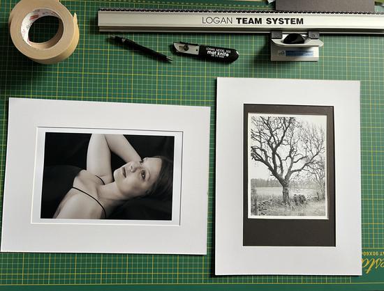 Two mounted photographs and cutting implements for mounting boards.