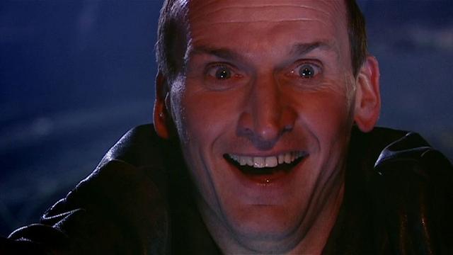 The Ninth Doctor, really happy because everybody lives.