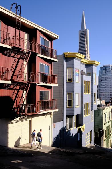 A steep street offering views of the Transamerica Pyramid.