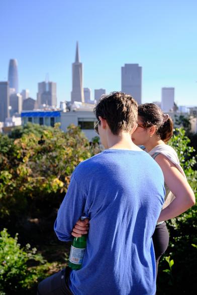 A couple enjoying the views of the city from Coit Tower.