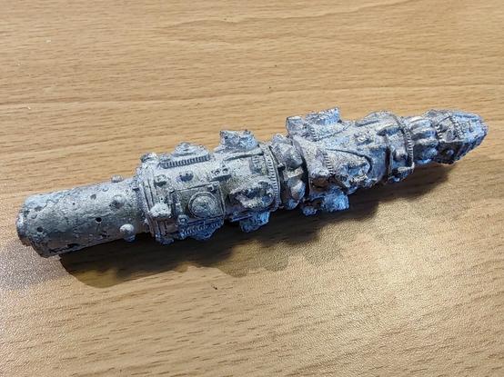 A Star Frontiers battleship miniature, with white corrosion on it.