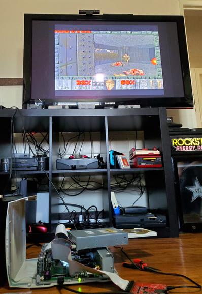 The aforementioned messy Pippin in the foreground, but Doom is playing on its output TV!