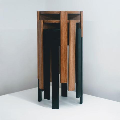 4 poplar stools stacked and nested into each other. The top two are stained a chestnut color and the bottom two are stained black.