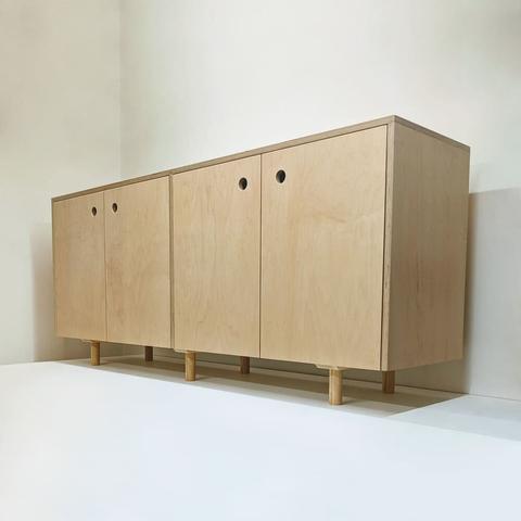 Maple sideboard with 4 doors and 6 legs. Each door has a hole in the upper corner that acts as a pull.