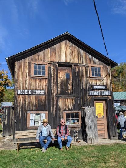 Photo of a large, old wooden building with 'Cheese House, Cookie House' painted on the front.