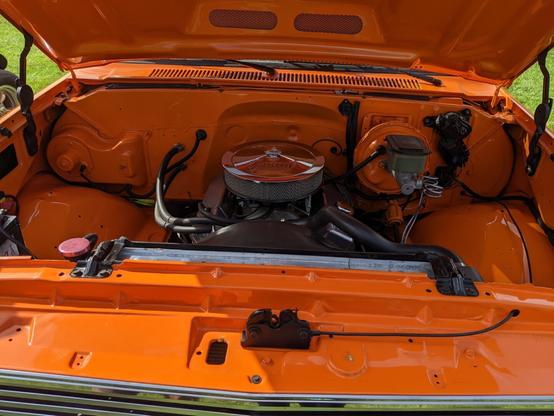 Photo of the old orange Chevy Silverado engine.