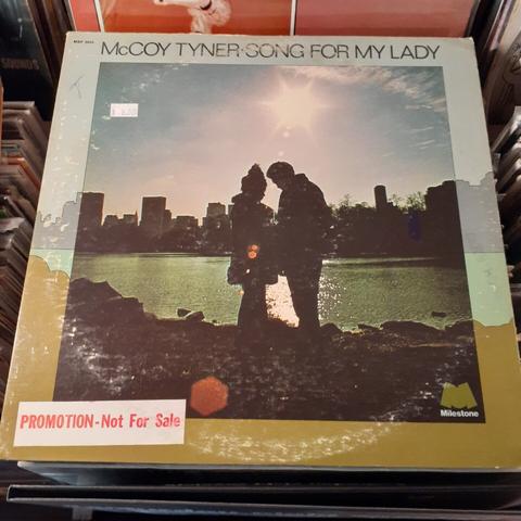 Album cover features photograph of MT and his lady standing by the shore of New York City with the sun shining brightly above.