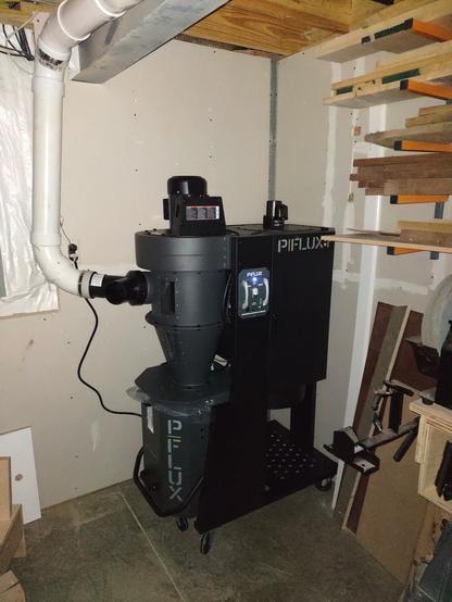 a Laguna p|flux 1 dust collector tucked in the corner