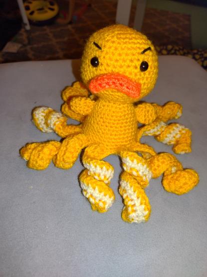 Grumpy yellow crochet duck with tentacles