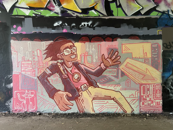 Light hearted graffiti - a young man with a skull T-shirt in a pinky city scene. You can see the palimpsest of pieces behind.